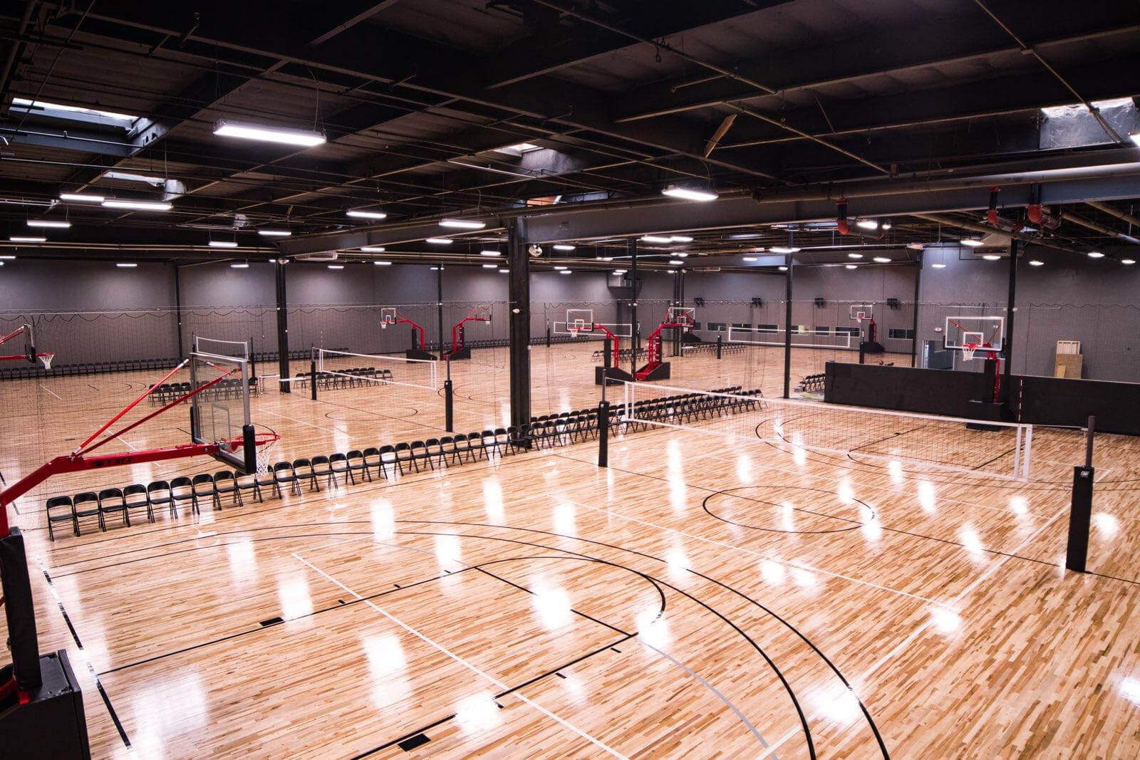 Inside the complex: premium wood courts set up for basketball and volleyball